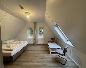 Bedroom under the roof in 44 - Aldubo Landhuis, Den Burg, Texel, with lots of light.