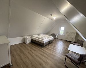 Large bedroom in 44 - Aldubo Landhuis, Den Burg, Texel, with wooden floor and lots of space.