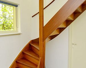 Houten trap in Vakantiehuis in Den Burg Texel naar bovenverdieping.