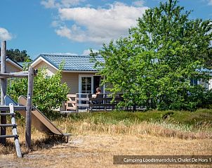 Chalet Hors 5p in Den Hoorn, Texel, biedt een uitnodigend terras met uitzicht op de groene omgeving van de Waddeneilanden.