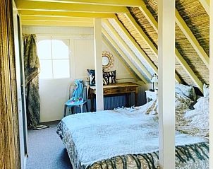 Gerumiges Schlafzimmer mit Holzbalken im Ferienhaus 't Kaaps Huussie in Oosterend, Texel.