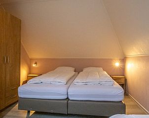 Knusse slaapkamer met tweepersoonsbed in vakantiehuis Nieuwlanderweg 69, De Koog, Texel, Waddeneilanden.