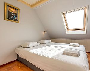 Schlafzimmer im Ferienhaus in Oosterend, Texel, Ferienhaus mit Doppelbett und Dachfenster auf den Watteninseln.