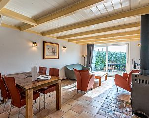 Gezellige woonkamer in Daalder vakantiehuis, Oosterend, Texel, met veel natuurlijk licht en comfortabele stoelen.