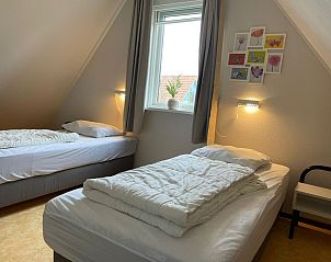 Gemtliches Mansardenzimmer im Ferienhaus Typ II - Nr. 47 Koolmees, Oosterend, Texel, mit zwei Einzelbetten.