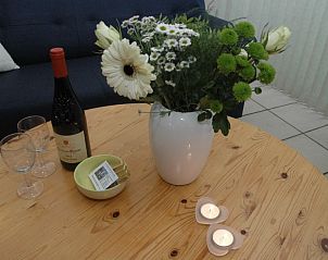 Gezellige eettafel met bloemen in Alkema bungalowverhuur Gortersmient, vakantiehuis Texel Waddeneilanden.