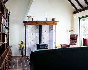 Knusse woonkamer met open haard in Het Rge Landje, vakantiehuis in Dennenbos, Texel.