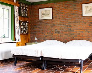 Comfortabele slaapkamer in Het Rge Landje, vakantiehuis in Dennenbos, Texel, met rustieke details.