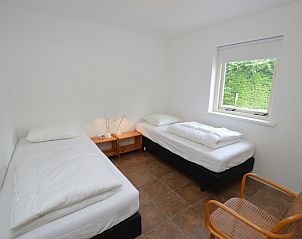 Schlafzimmer mit zwei Einzelbetten in Ferienhaus de Parel 182, De Dennen, Texel.