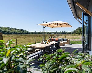 Terrace of Holiday Home 2 in De Dennen, Texel with views of nature and comfortable seating.