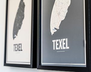 Wall decoration in Holiday Home 2 on Texel with maps of the island.