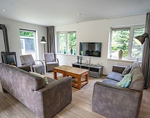 Comfortable sitting area in Holiday home de Parel 152, De Dennen, Texel, overlooking the garden.