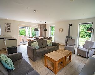 Spacious and bright living room of Holiday home de Parel 152, De Dennen, Texel, with access to terrace.