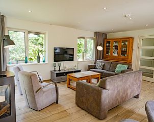 Stylish living room of Holiday Home de Parel 152 in De Dennen, Texel, with lots of natural light.