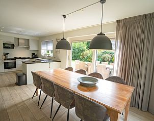 Dining room in Holiday home the Pearl 152, De Dennen, Texel, with large dining table and views of nature.