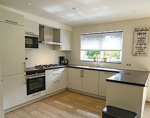 Modern kitchen in Holiday home de Parel 152, De Dennen, Texel, with all necessary appliances.