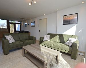 Spacious sitting area in Holiday Home de Parel 198, De Dennen, Texel with comfortable sofas.