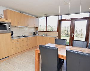 Modern kitchen in Holiday home de Parel 198, De Dennen, Texel with dining area and lots of light.
