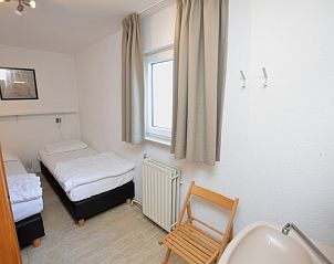 Bedroom with two single beds in Holiday home de Parel 198, De Dennen, Texel.