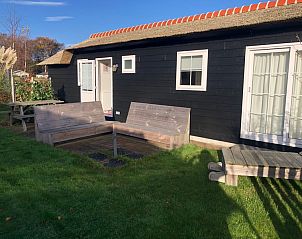 Cozy terrace at Vakantiepark de Bremakker, Akkerveld 15, De Dennen Texel, vacation home with outdoor space.