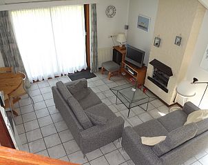 Cozy living room of Holiday home Gortersmient 330, Texel with comfortable sofas.