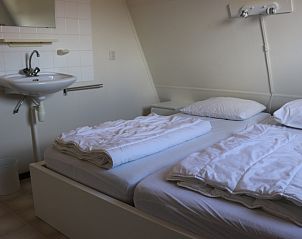 Comfortable bedroom in Holiday home Gortersmient 330, Texel with sink.