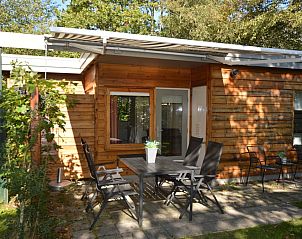 Cozy terrace at Holiday Home De Nagtegaal 19, De Dennen, Texel, perfect for outdoor dining.