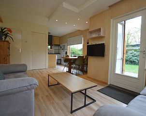 Open living room and kitchen in Holiday home De Nagtegaal 19, De Dennen, Texel, with access to the garden.