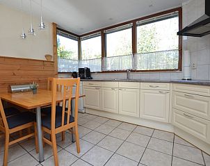 Dining area and kitchen in Holiday home de Parel 222, De Dennen, Texel.