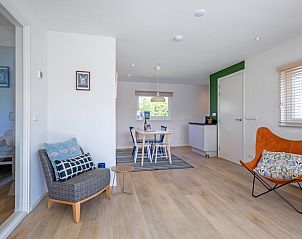 Stylish reading corner in Bungalowpark Uterste Coogh - Bungalow 128 - Gerrit, De Dennen, Texel, with comfortable chair.