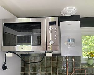 Detail of microwave oven and boiler in kitchen of Wollewei vacation home, De Dennen, Texel.