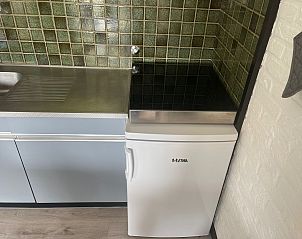 Compact refrigerator in the kitchen of Wollewei vacation home, De Dennen, Texel.