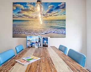 Stylish dining area in Bungalowpark Uterste Coogh - Bungalow 82 - De Luwte, De Dennen, Texel with art on the wall.
