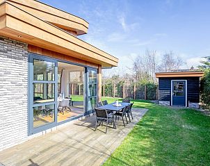 Enjoy the terrace of Holiday Home De Vlinder in Bungalowpark 't Hoogelandt, located in the green surroundings of De Dennen, Texel.