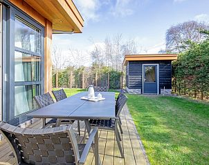 Relax on the outdoor terrace of Holiday Home De Vlinder in Bungalowpark 't Hoogelandt, surrounded by the nature of De Dennen, Texel.