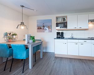 Dining area and fully equipped kitchen in Apartment Bos en Duin 12, De Dennen, Texel, perfect for cozy meals.