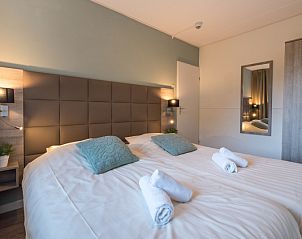 Spacious bedroom with double bed and modern furnishings in Apartment Bos en Duin 12, De Dennen, Texel.