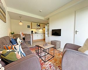Stylish interior of Apartment Bos en Duin 31 in De Dennen, Texel with open kitchen and comfortable seating.