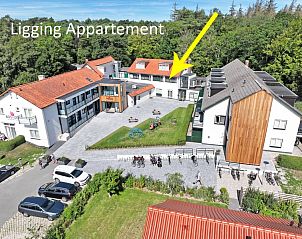 Luchtfoto van Appartement Bos en Duin 26, De Dennen, Texel met groene omgeving en nabijgelegen faciliteiten.