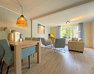 Spacious sitting area in Apartment Bos en Duin 22, De Dennen, Texel overlooking the green surroundings.