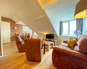Spacious sitting area in Apartment Bos en Duin 34, De Dennen, Texel with modern furniture.