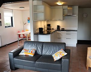 Stylish interior of Holiday Home Gortersmient 324, De Dennen, Texel with open kitchen and spacious sitting area.