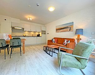 Cozy sitting area in Apartment Bos en Duin 08, De Dennen, Texel, overlooking the green surroundings.