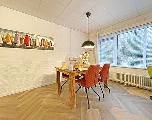 Dining area with artwork in Apartment Bos en Duin 04, De Dennen, Texel, ideal for cozy meals.