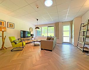 Bright living room in Apartment Bos en Duin 06, De Dennen, Texel overlooking the green surroundings.