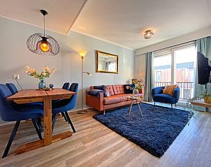 Stylishly furnished sitting area in Apartment Bos en Duin 27, De Dennen, Texel with comfortable sofa and decorative elements.