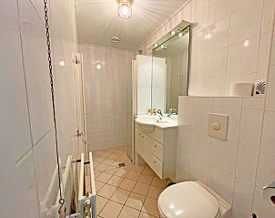 Balcony of Apartment Bos en Duin 27, De Dennen, Texel with beautiful views of the surroundings and comfortable seating.