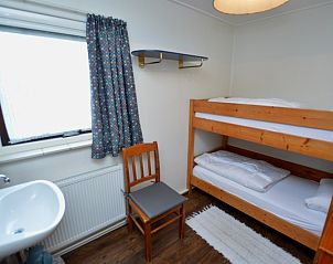 Gezellige kinderkamer in Vakantiehuis de Parel 160, Texel, met stapelbed en speelse inrichting voor een aangenaam verblijf.
