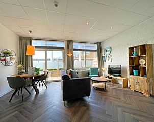 Cozy sitting area in Apartment Bos en Duin 02, De Dennen, Texel with comfortable sofas and cozy decorations.
