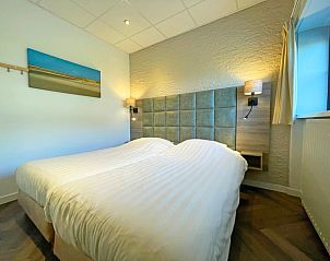 Comfortable bedroom in Apartment Bos en Duin 02, De Dennen, Texel with double bed and mood lighting.